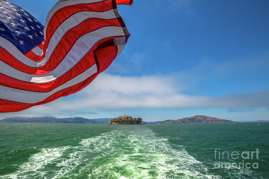Alcatraz island with american flag Photograph by Benny Marty