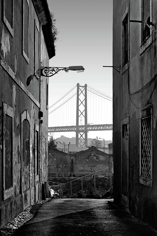 Alley and bridge over Tagus, Lisbon Photograph by Carlos Caetano