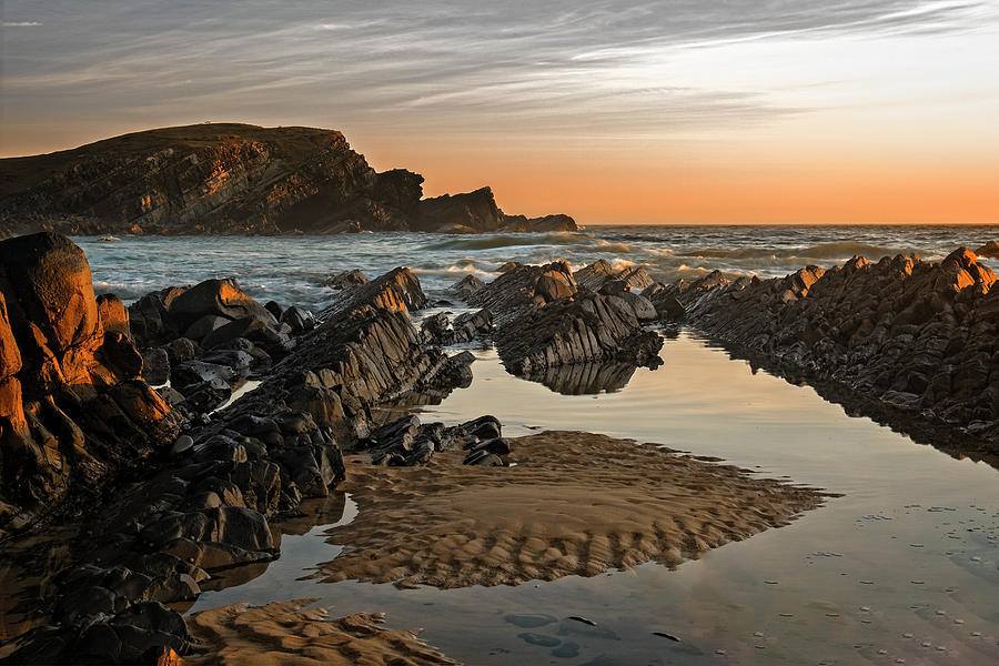 Amazing rock formations on the beach at sunrise Photograph by Catherine Reading