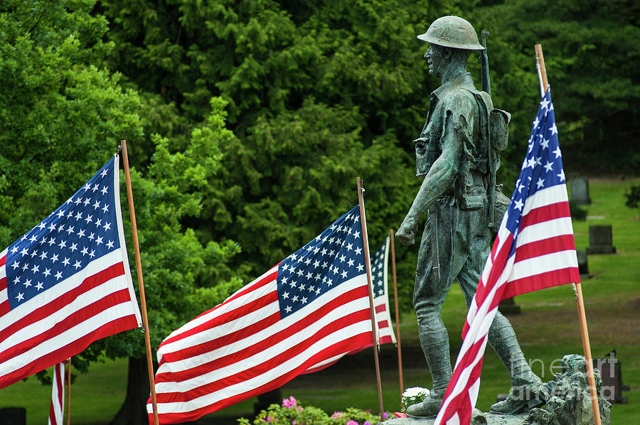American Flags at Cemetery with Soldier Sculpture Photograph by Jim Corwin