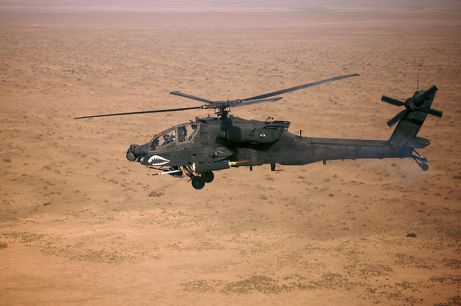 Helicopter Photograph - An Ah-64d Apache Longbow Fires A Hydra by Terry Moore