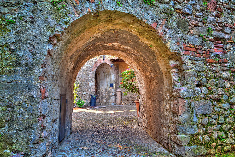 an archway in the Scaliger Castle of the charming village Malcesine Photograph by Gina Koch