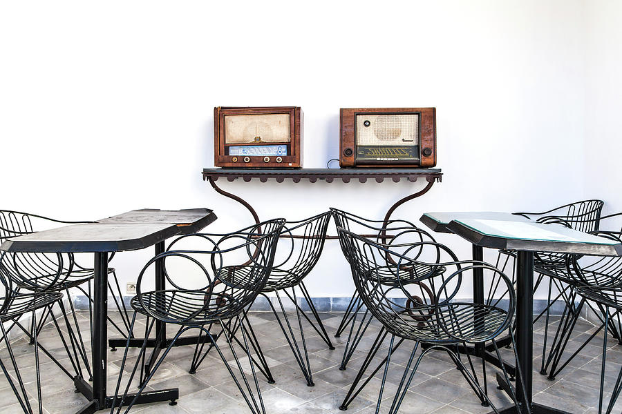 An Arrangement Of Tables And Chairs And Two Old Radios Photograph by Gina Koch