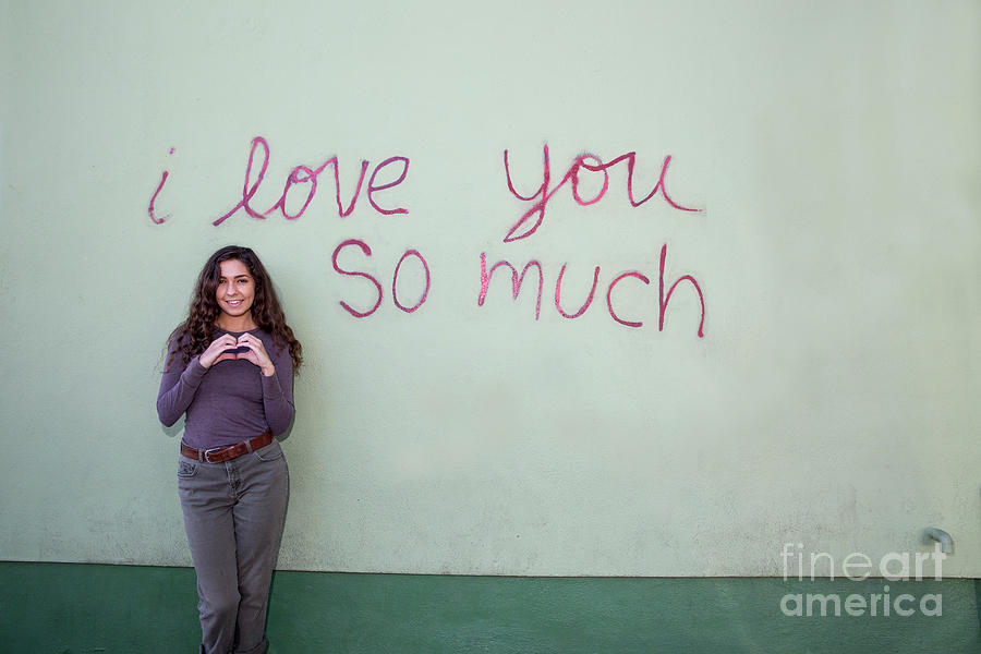 I Love You So Much Photograph - An attractive local Austin girl poses in front of the iconic I Love You So Much Mural in Soco by Dan Herron