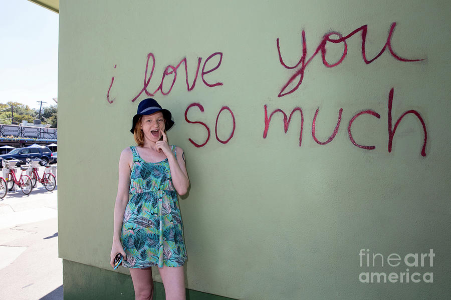 Austin Photograph - An Austin local poses in front of the famous I love you so much  by Dan Herron
