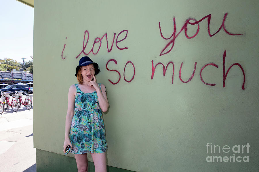 Austin Photograph - An Austin local poses in front of the famous I love you so much mural in South Congress, Austin, Texas by Dan Herron