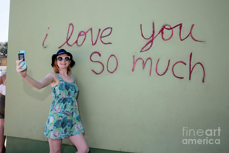 Austin Photograph - An Austin local takes a selfie at the famous I love you so much mural in South Congress Austin Texas by Dan Herron