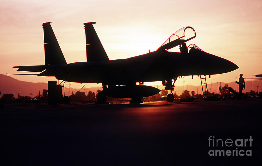Airplane Photograph - An F-15c Eagle Aircraft Silhouetted by Stocktrek Images