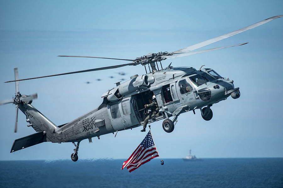 An MH-60S Sea Hawk helicopter displays the American flag. Painting by Celestial Images