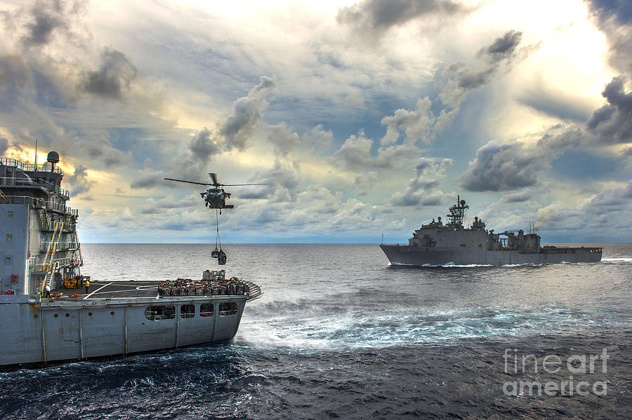 Sailors Painting - An MH-60S Sea Hawk helicopter  lifts pallets of supplies by Celestial Images