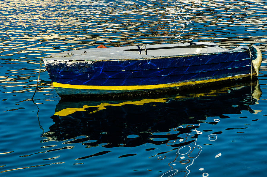 Anchored boat Photograph by Wolfgang Stocker