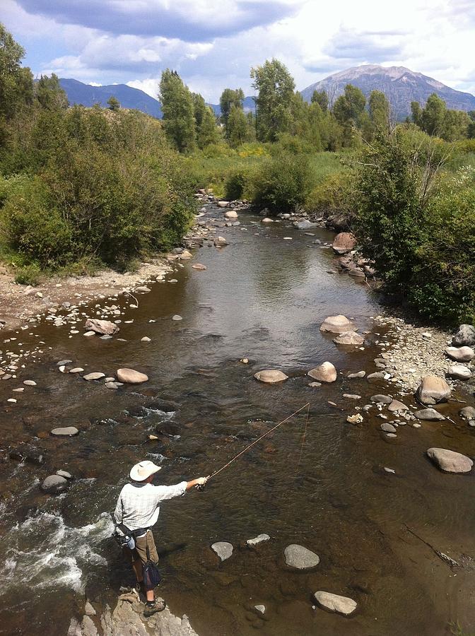 Angler on rock fishing a river Photograph by Mark Williams Image