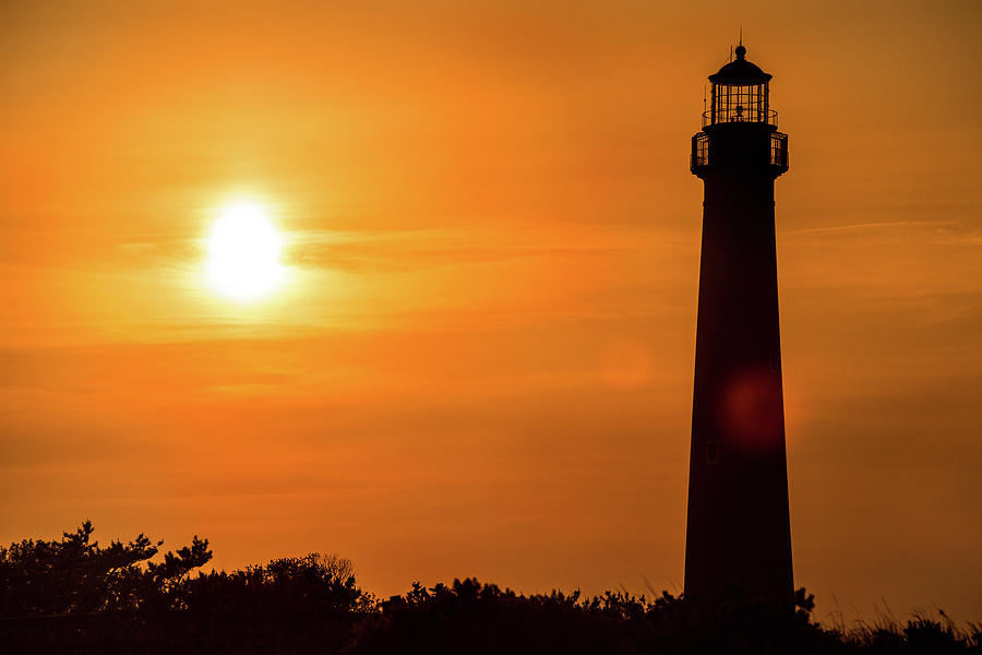 Beach at sunset in Cape May, New Jersey, USA with the Cape May Point  Lighthouse in the background Stock Photo - Alamy