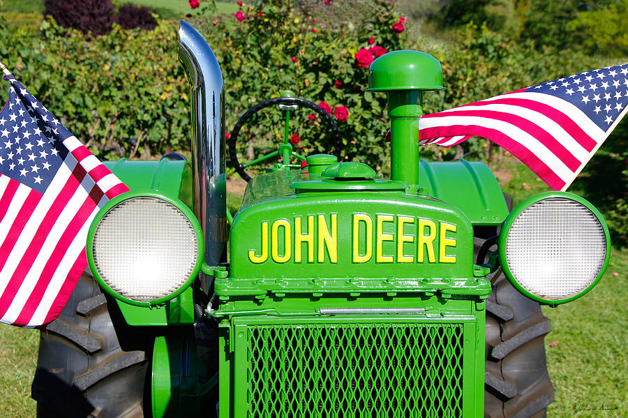Flag Photograph - Antique John Deere tractor with American flags by John Harmon