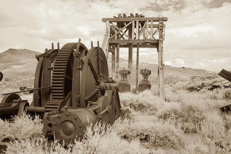 Antique mining equipment in Bodie, California in sepia Photograph by Karen Foley