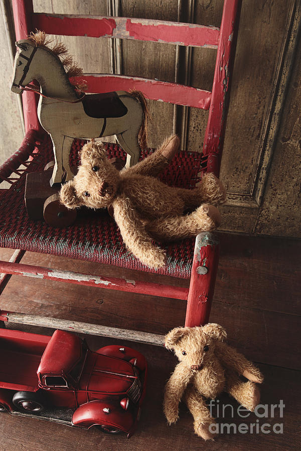 Antique toys on red wooden chair Photograph by Sandra Cunningham