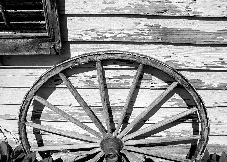 Antique wagon wheel in Black and white Photograph by Photographic Arts And Design Studio