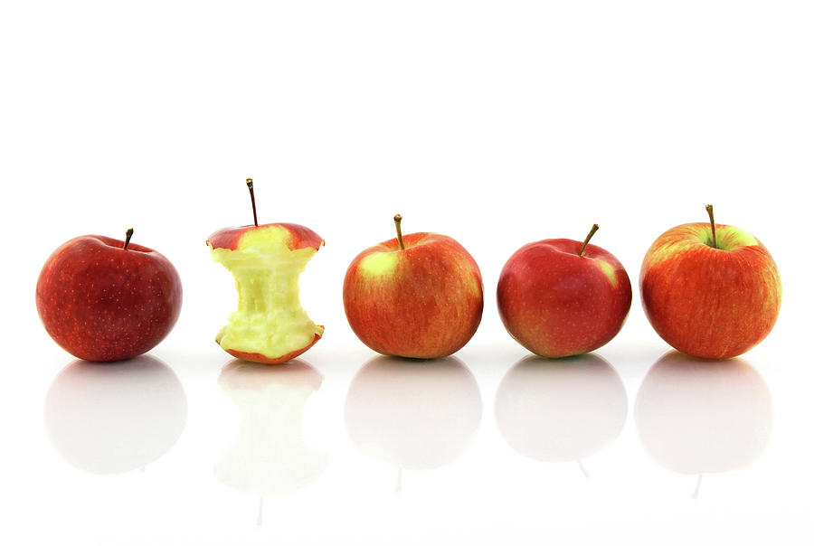Apple Photograph - Apple core among whole apples by GoodMood Art