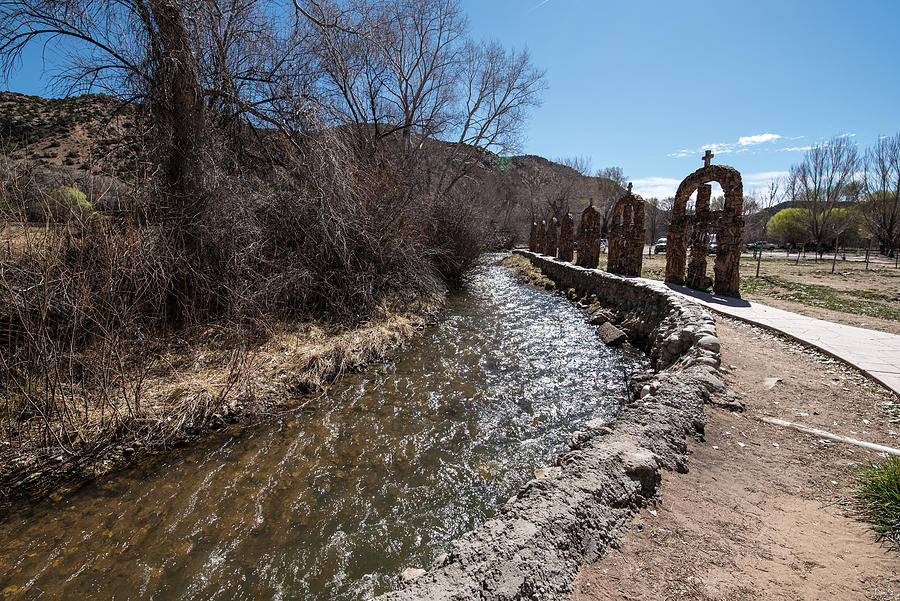 Arches and Acequia at Santuario Photograph by Tom Cochran