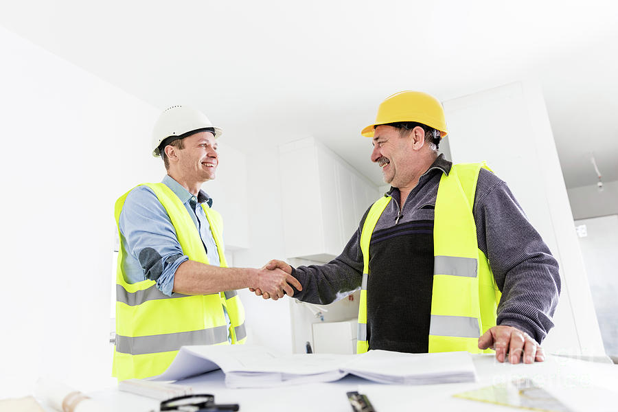 Architect and construction engineer handshake. Photograph by Michal Bednarek
