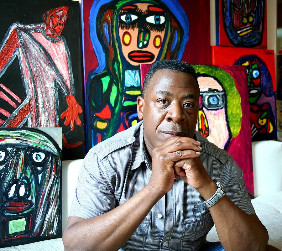 Artist Darrell Urban Black Surrounded By His Artwork Photograph