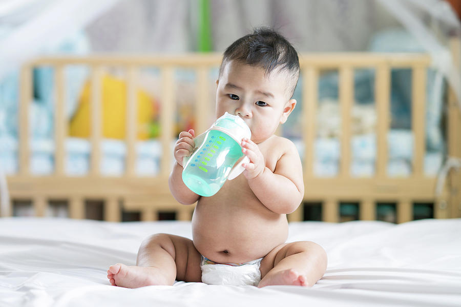 Asian baby drink water by plastic bottle Photograph by Anek Suwannaphoom