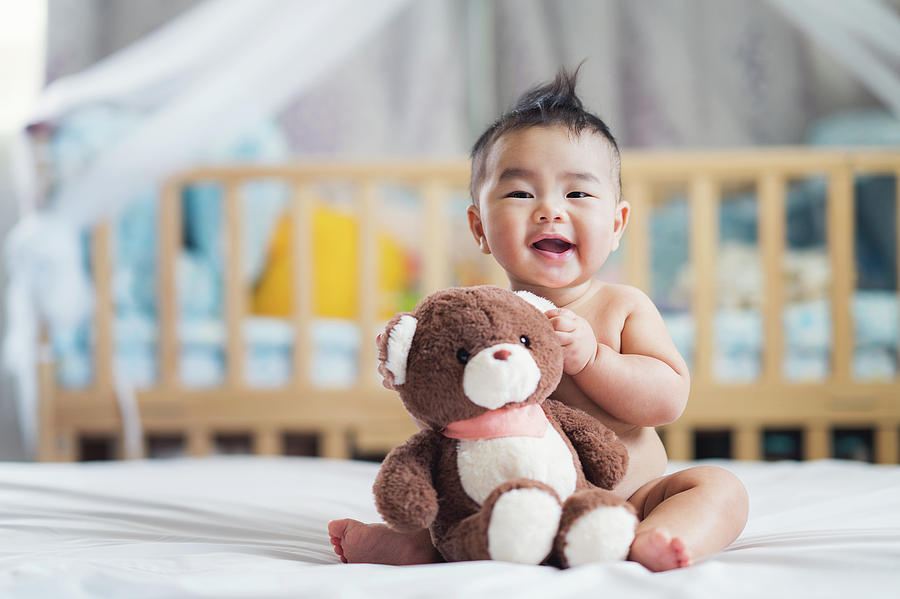 Asian baby sit with teddy bear Photograph by Anek Suwannaphoom
