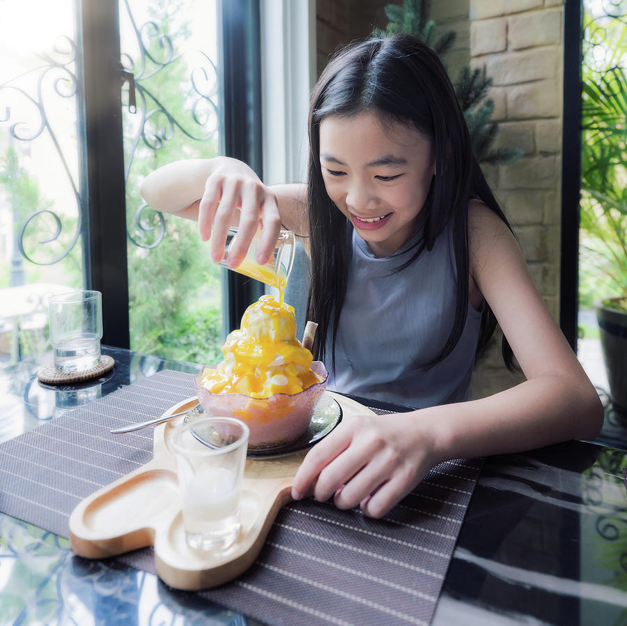 Asian girl make topping for  mango bingsu Photograph by Anek Suwannaphoom