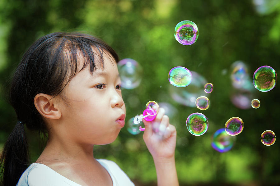Asian girl play a bubble in nature Photograph by Anek Suwannaphoom