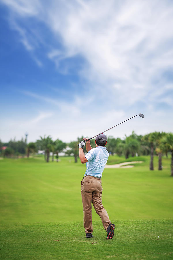 Asian Golf player on tee off green Photograph by Anek Suwannaphoom