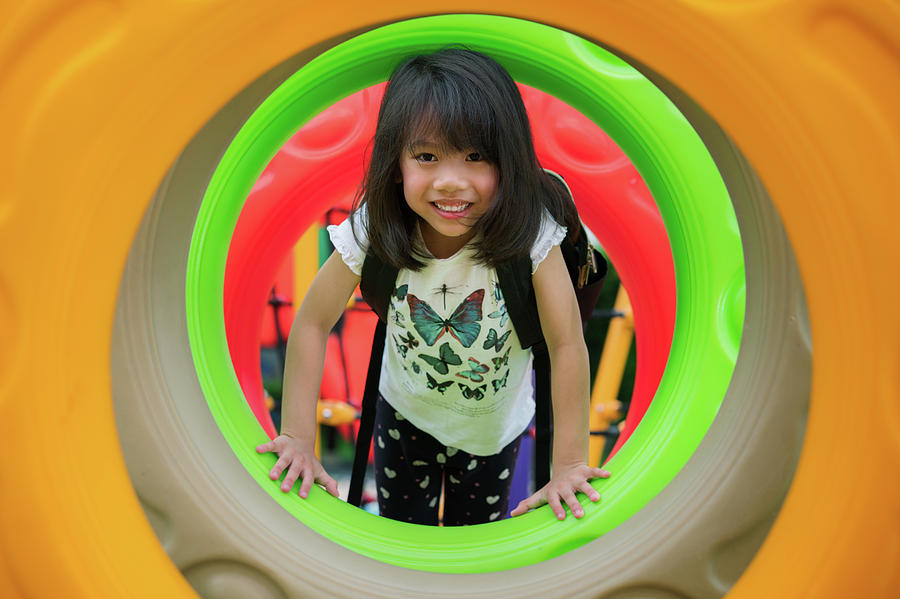Asian kid fun and happy from play a donus ring in playgroung  Photograph by Anek Suwannaphoom