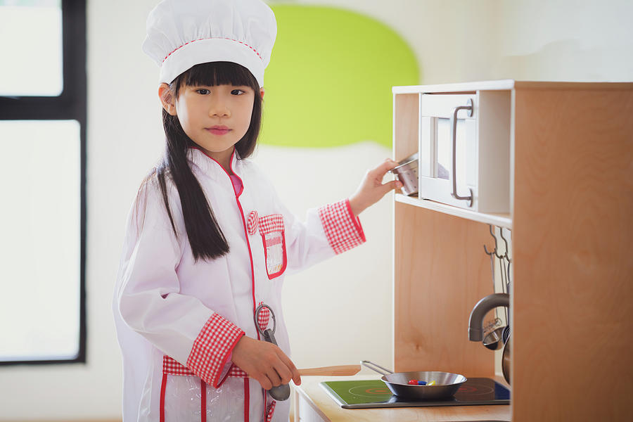 Asian kid in cooking uniform  Photograph by Anek Suwannaphoom
