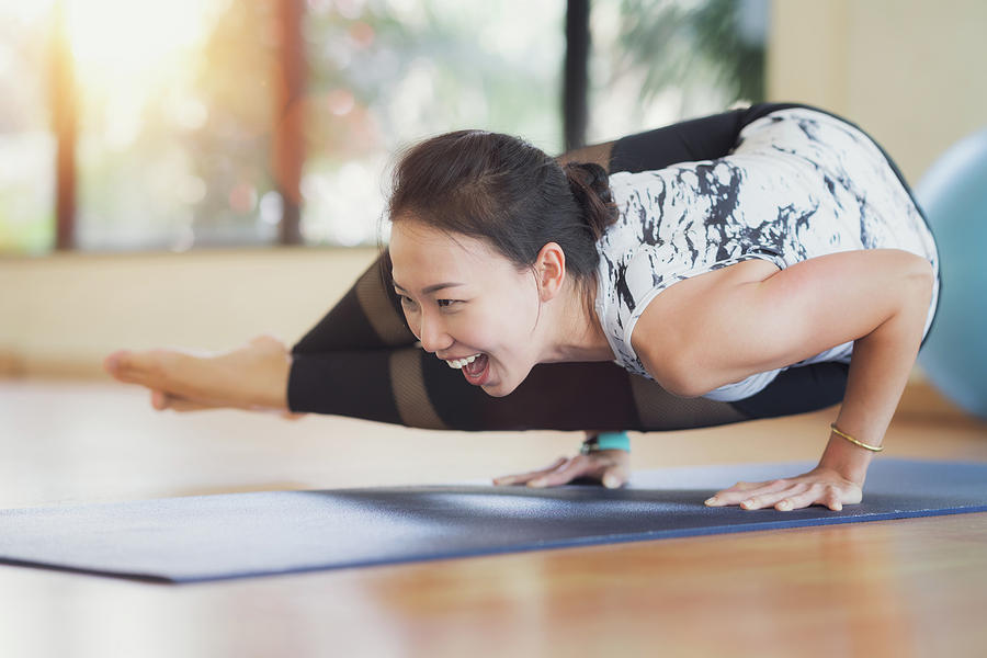 Asian lady atke Yoga exercise in fitness center Photograph by Anek Suwannaphoom