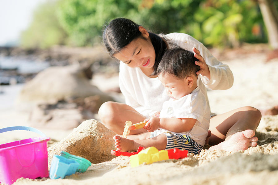 Asian mother and baby play sand and toy togather  Photograph by Anek Suwannaphoom