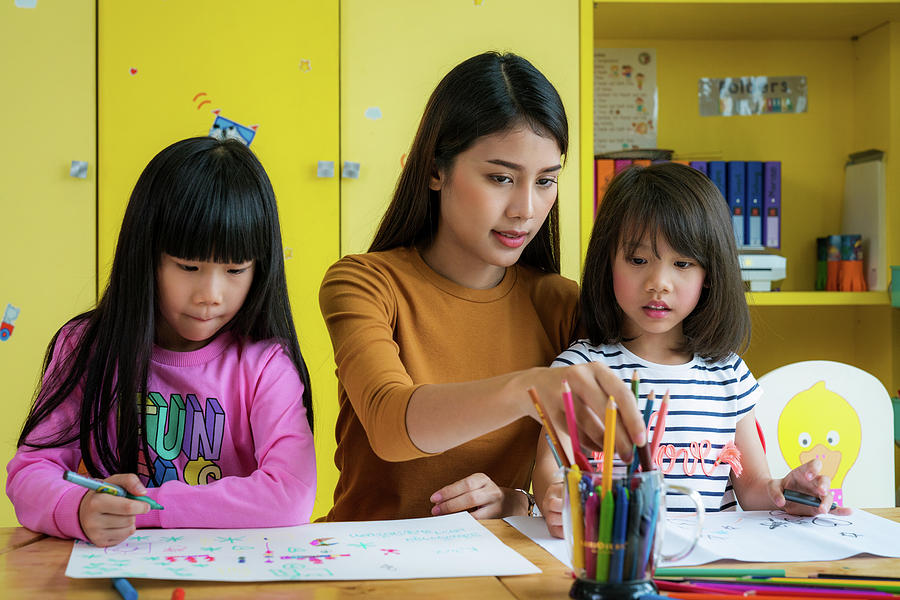 Asian teacher and preschool student in art class Photograph by Anek Suwannaphoom