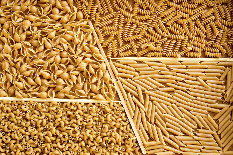 Assorted whole wheat pasta on wooden tray Photograph by Karen Foley