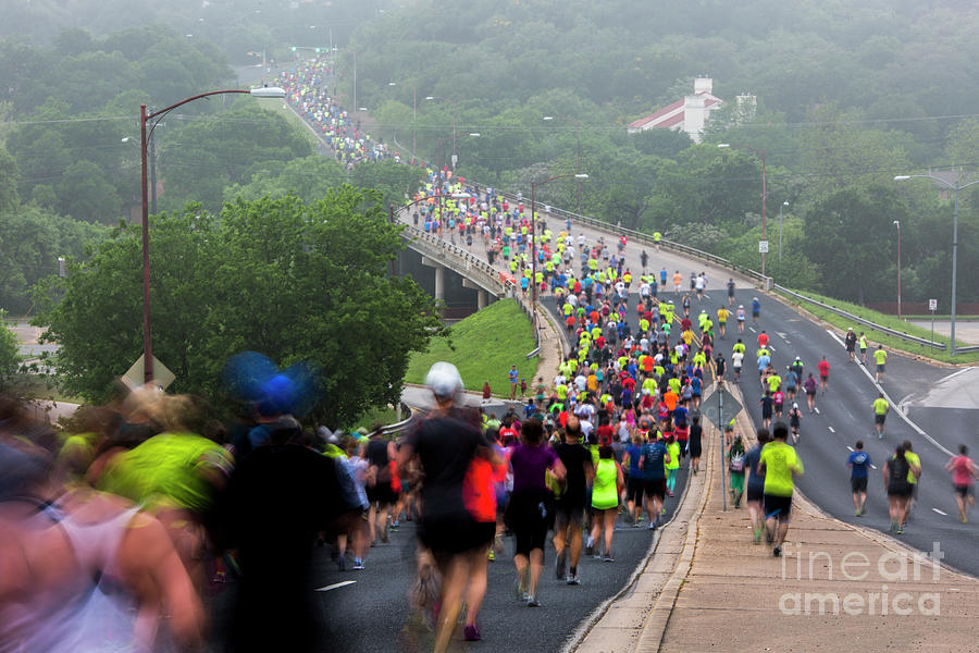 Sports Photograph - Austins Cap10K runners make their way down Enfield Road on a foggy morning by Dan Herron