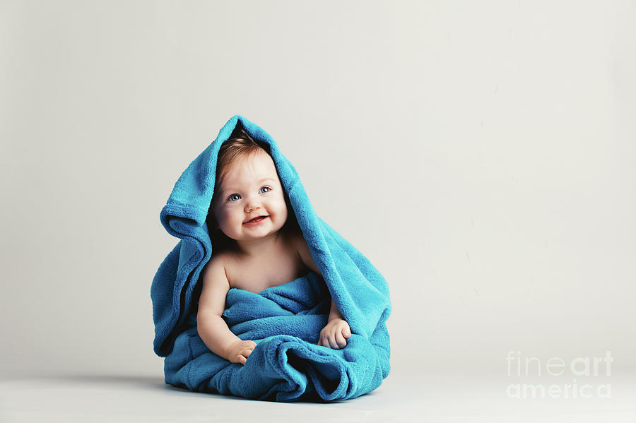 Baby girl covered with a blue warm blanket Photograph by Michal Bednarek