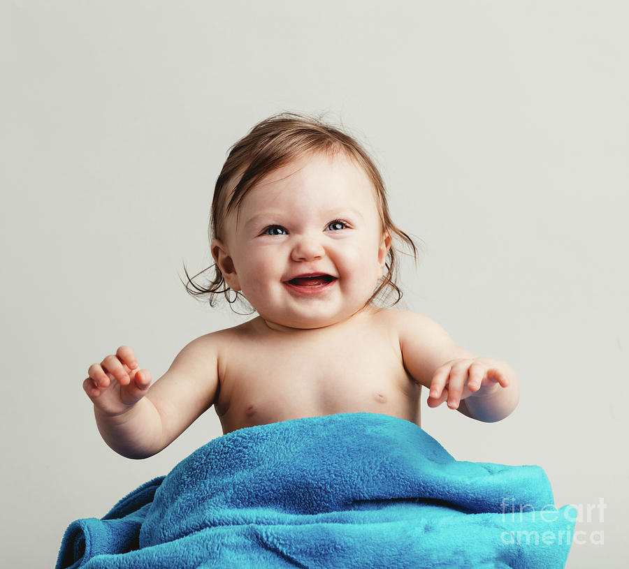 Baby girl sitting in a blue blanket, smiling Photograph by Michal Bednarek