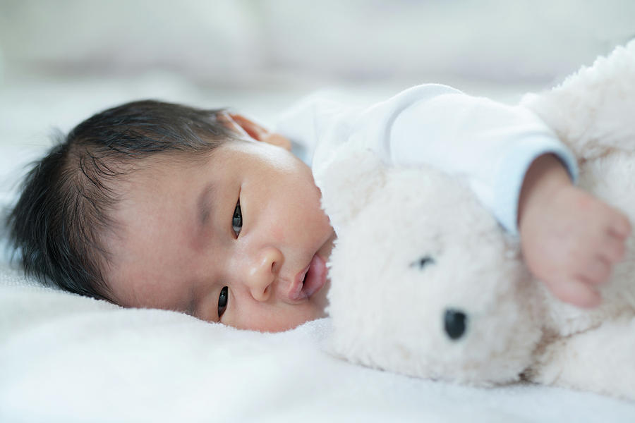 Baby sleep with teddy bear Photograph by Anek Suwannaphoom