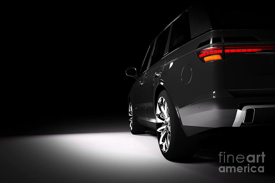 Back view of modern black SUV car in a spotlight Photograph by Michal Bednarek