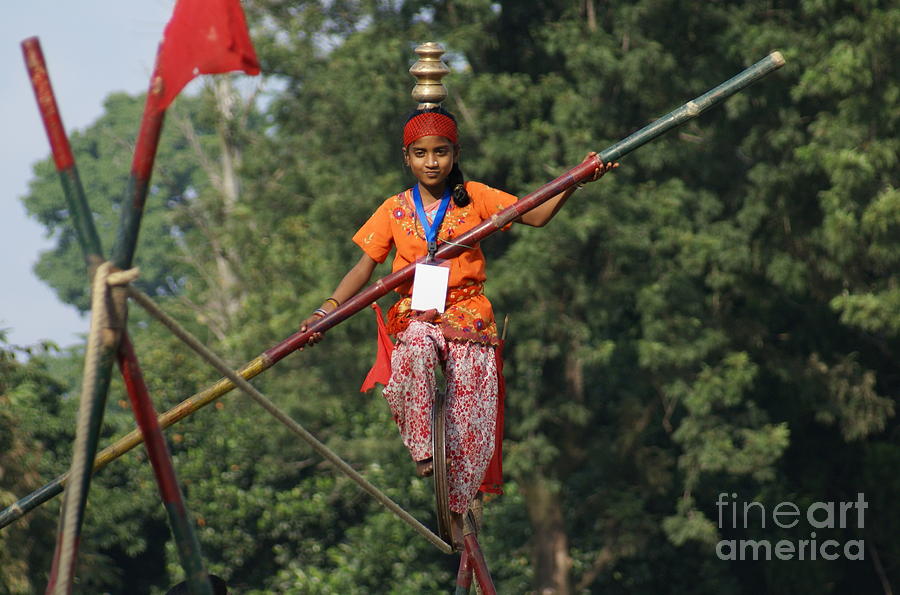 Balance - Girl Driving a Wheel on a Rope Photograph by Padamvir Singh