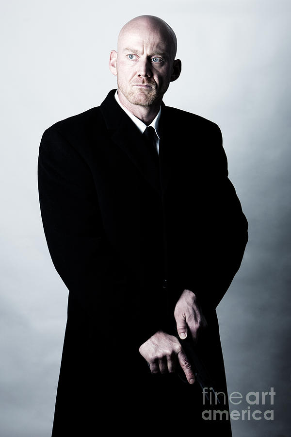 Actor Photograph - Bald Headed Man Wearing Heavy Black Overcoat Cocking Automatic Handgun Model Released Image by Joe Fox