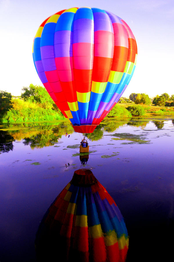 Balloon touching the water Photograph by Jeff Swan