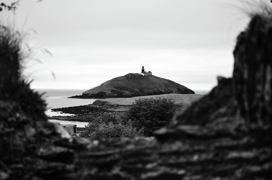 Ballycotton Ireland Lighthouse through Village Stone Wall County Cork Black and White Photograph by Shawn OBrien