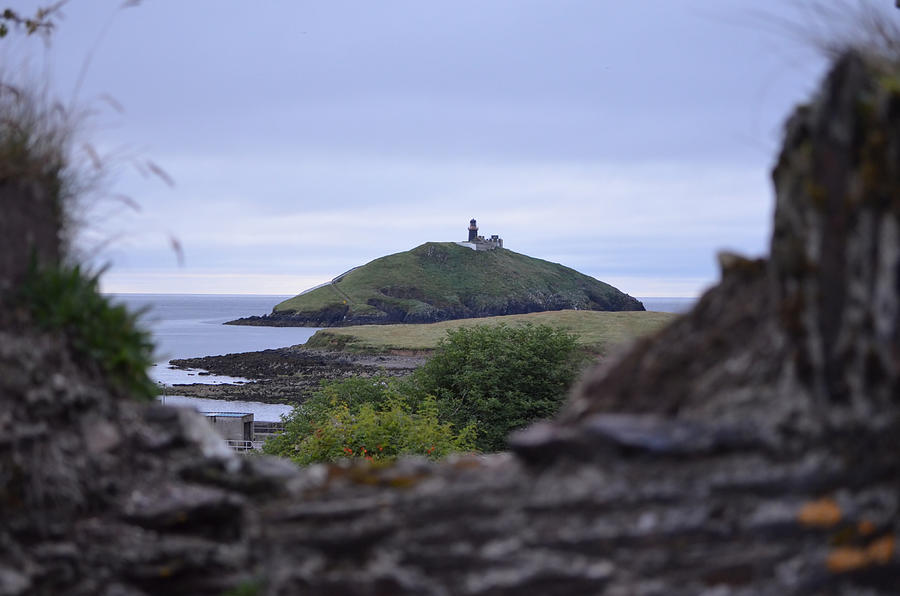 Ballycotton Ireland Lighthouse through Village Stone Wall County Cork Photograph by Shawn OBrien