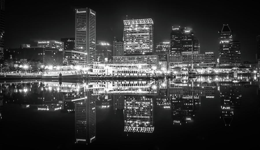 Baltimore  skyline and docks reflecting in the water at night Photograph by Alex Grichenko