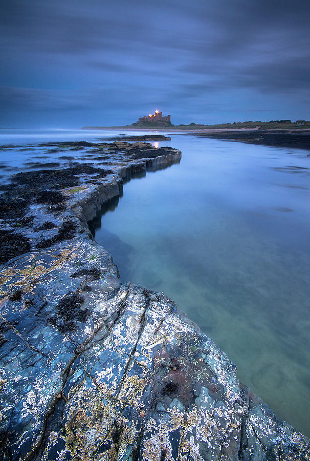 Bamburgh Castle blue hour from the rocks after dark Photograph by Anita Nicholson Bamburgh Castle blue hour from the rocks after dark Photograph by Anita Nicholson