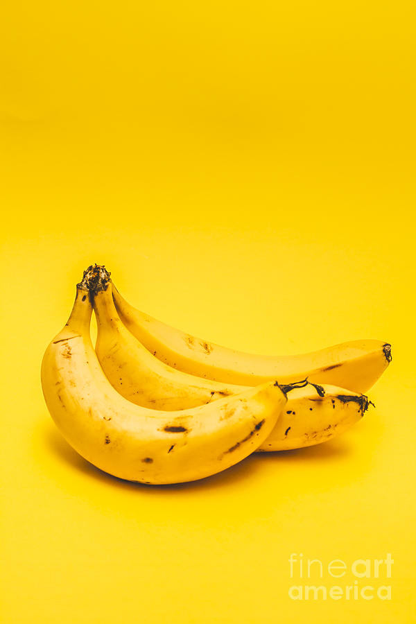 Banana Photograph - Bananas on yellow background by Jorgo Photography