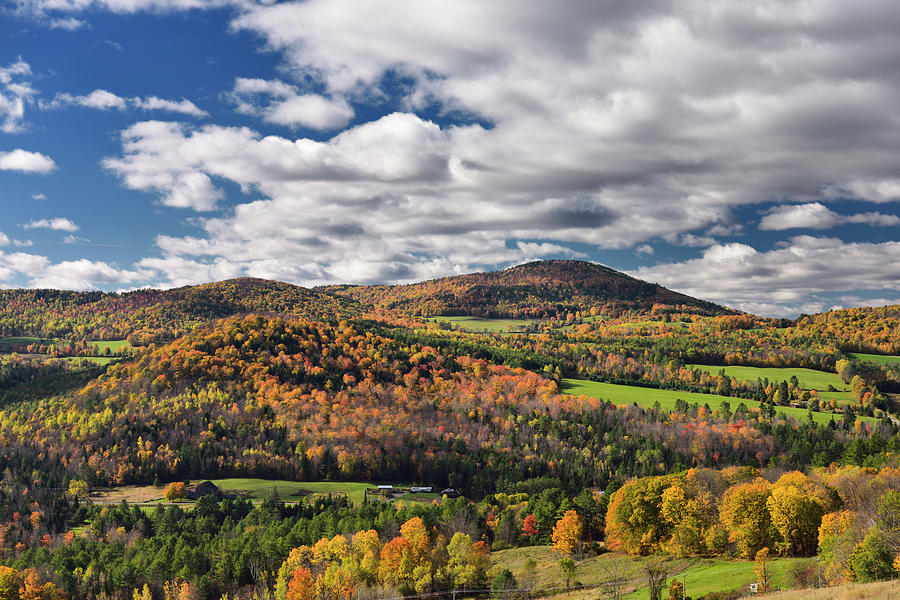 Center valley with hills in Fall colors Vermont with clou